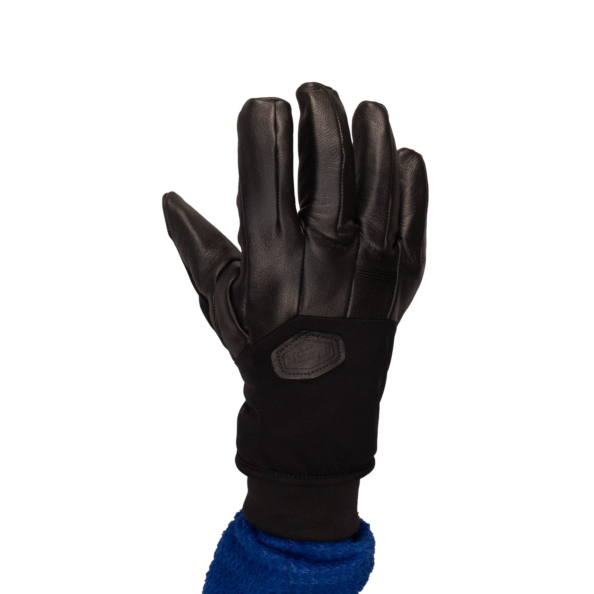 The Loaf Glove by Mainers features a black leather exterior with a fabric cuff, set against a white background, providing both protection and warmth.