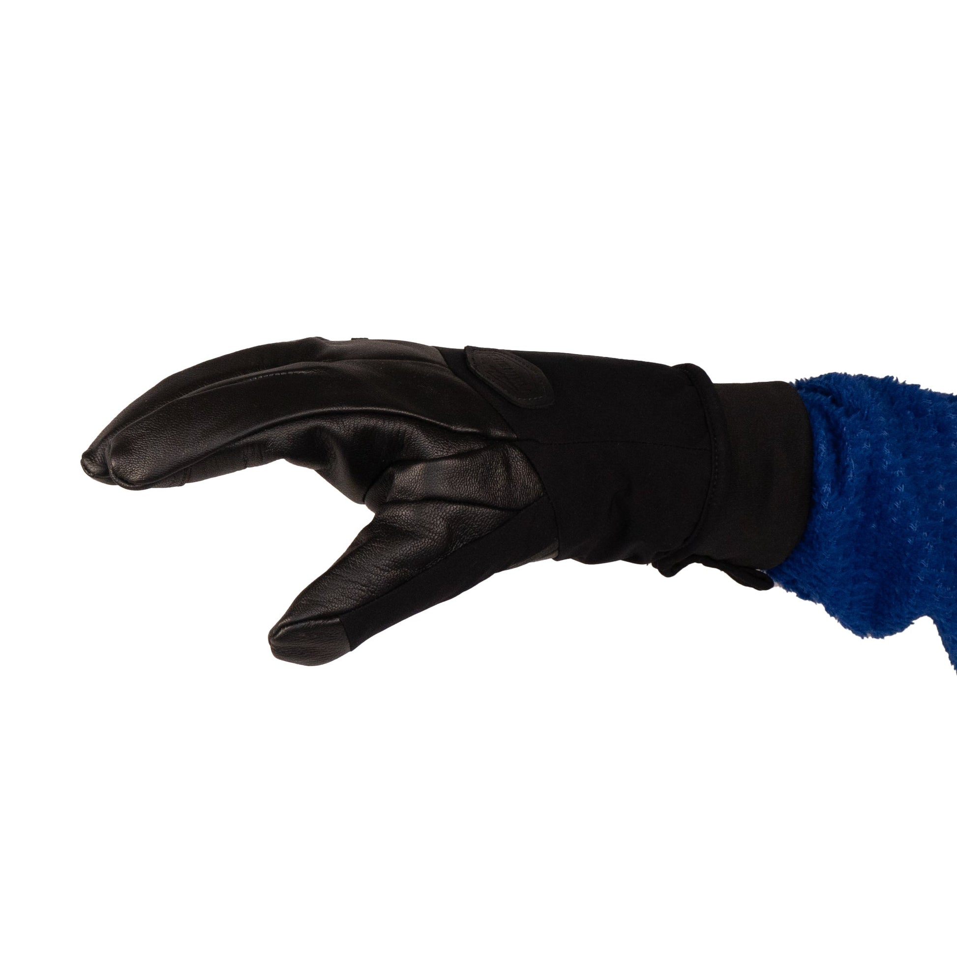 A person wearing the Loaf Glove by Mainers, showcasing its leather palm and fingers, gestures stylishly against a stark white background.