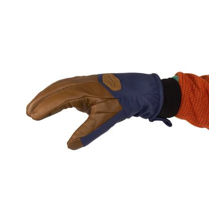 A hand adorned with Mainers' Loaf Glove, showcasing a brown and navy blue design with a hint of orange sleeve visible, delivers both style and warmth.