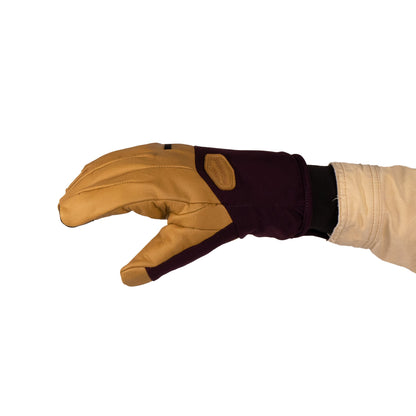 The Loaf Glove from Mainers, recognized for its warmth and protection, is displayed with a gloved hand extending outward in a brown and tan design against a white background.