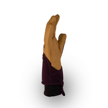 A glove called the Loaf Glove by Mainers, featuring brown and dark purple hues, stands upright with the palm side visible against a white background, exuding warmth and style.