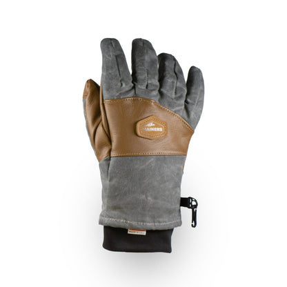 Introducing the Ragged MT Glove by Mainers: a versatile winter glove in grey and brown with a leather patch and wrist strap, combining style and functionality for any adventure.