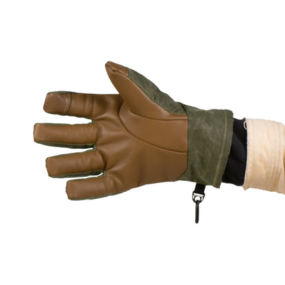 Wearing Mainers' Ragged MT Glove, known for its rugged brown and green design, a person holds their hand outstretched to the side against a plain white background, ready for a winter adventure.