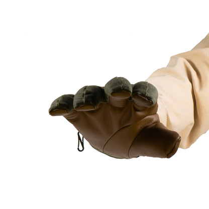 A person stands against a plain white background, ready for any winter adventure, wearing the Mainers Ragged MT Glove designed to resemble a bear paw.